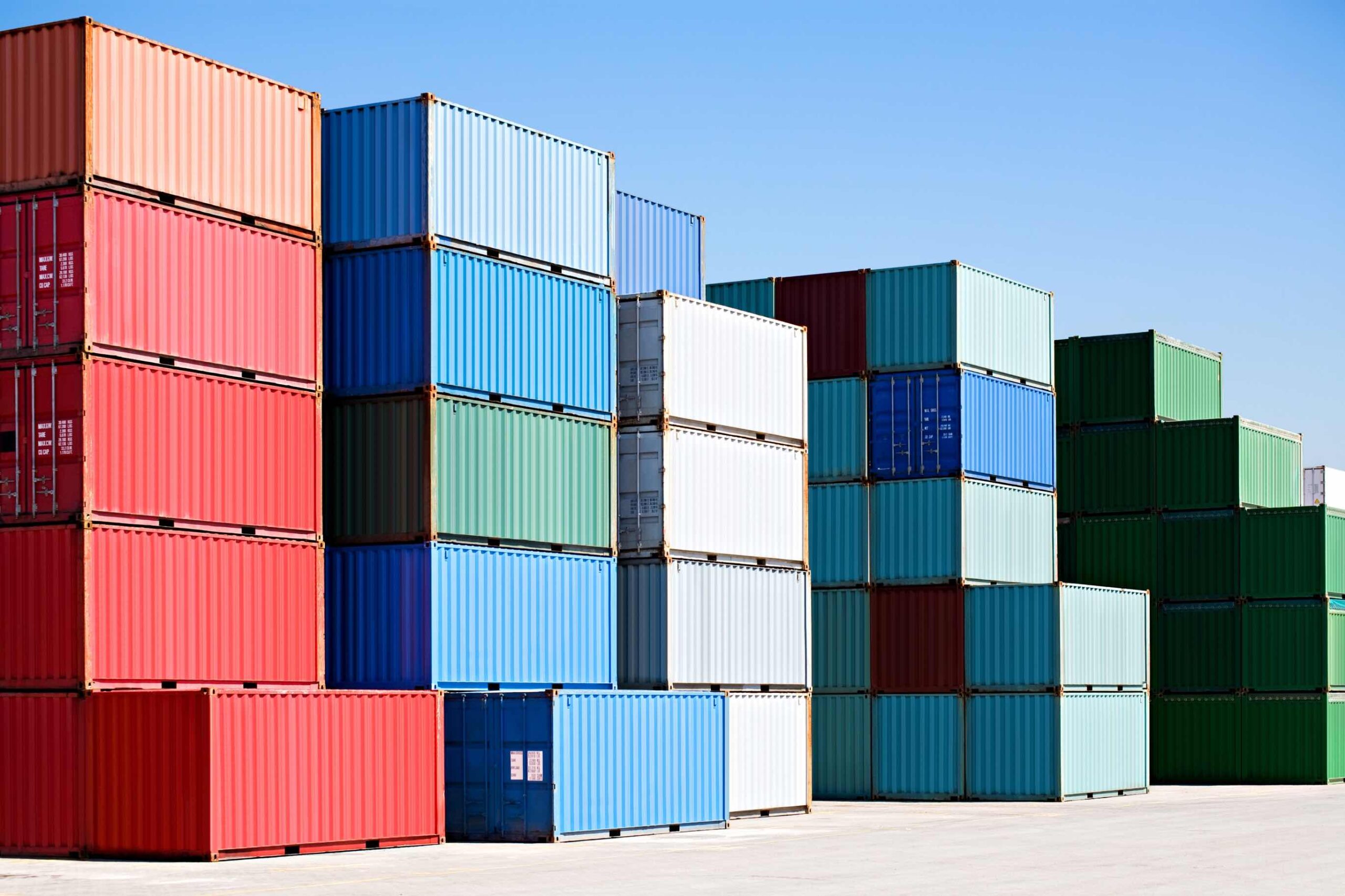 A shipping container yard with stacks of cargo containers.