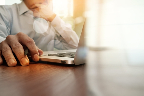 A man working on a laptop.