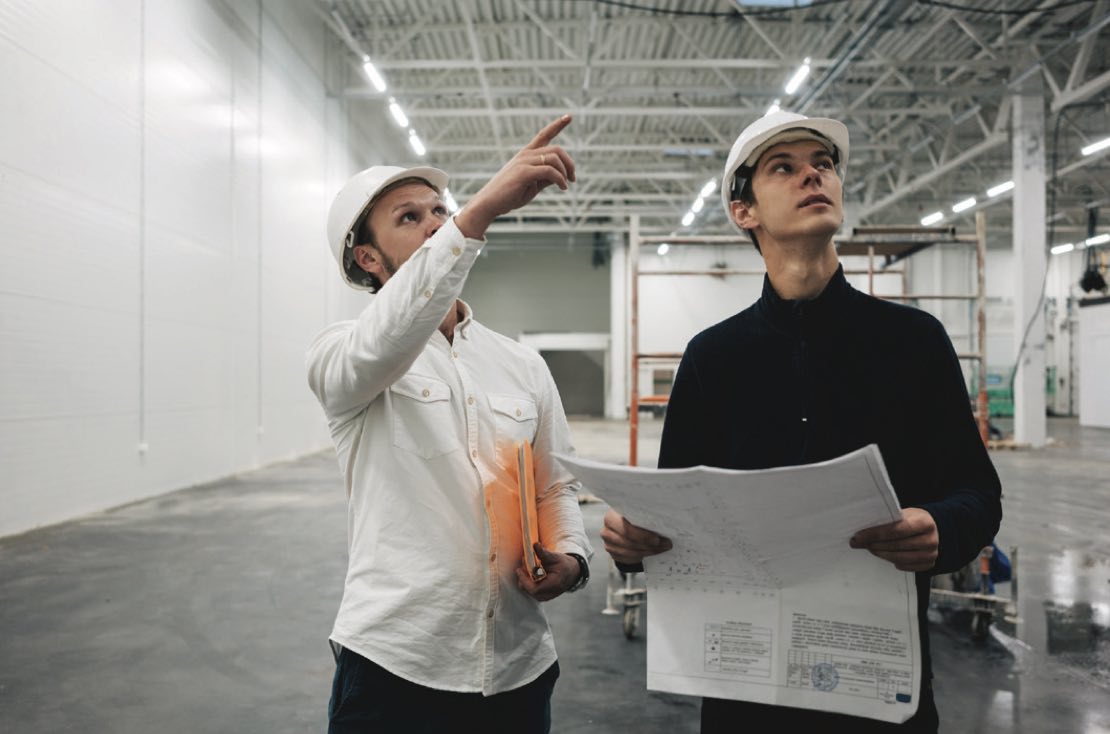 Two men inspecting a building.