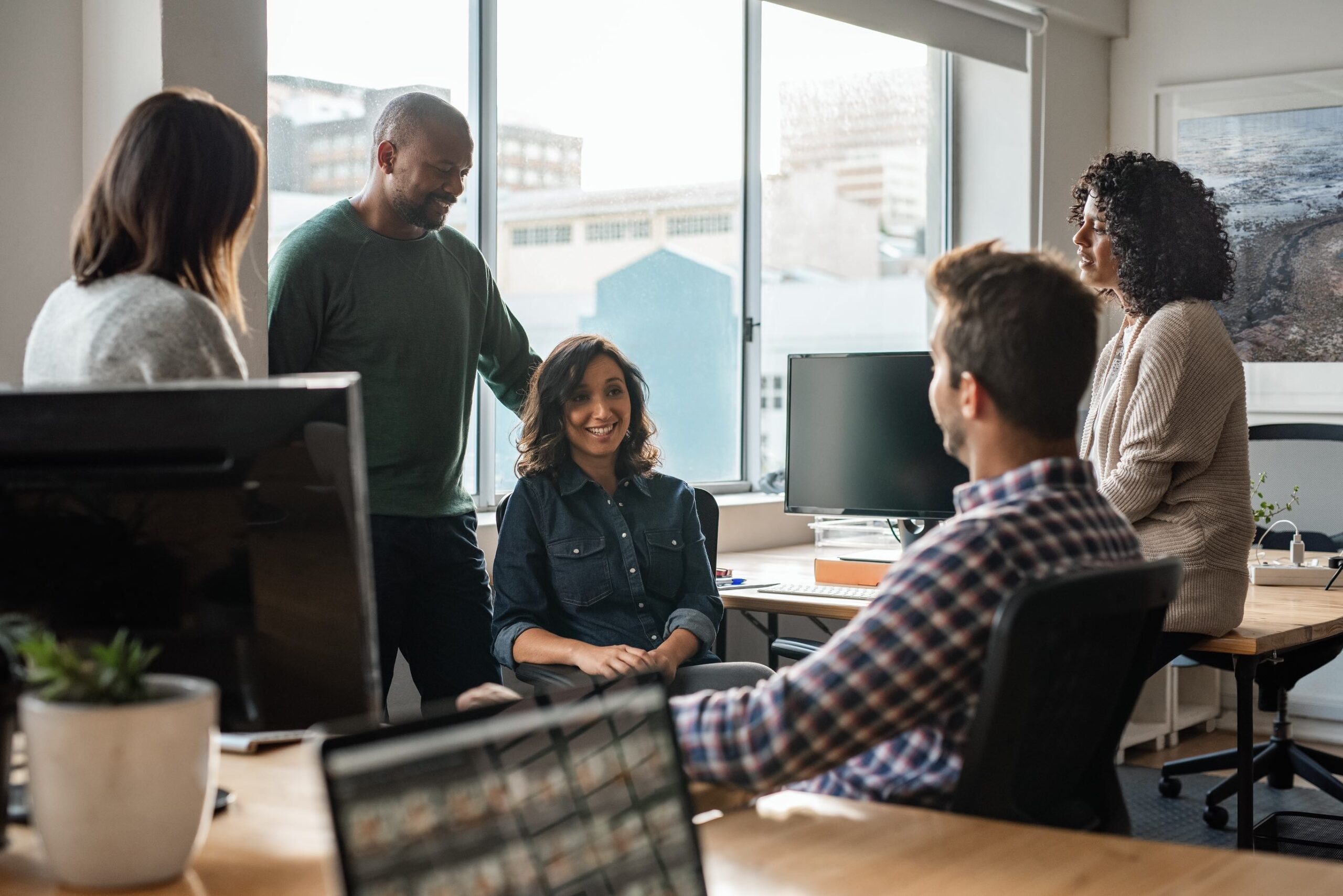 A group of five coworkers in the office.