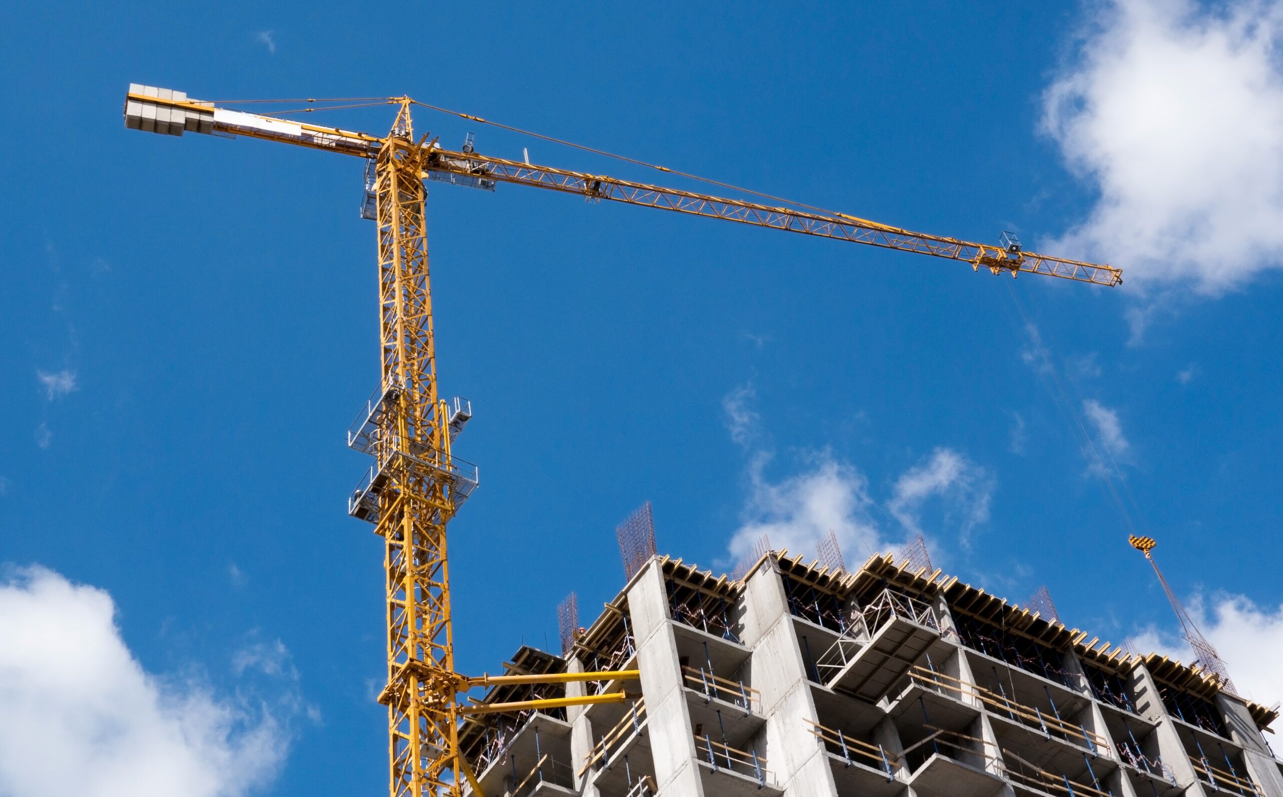 Resilient buildings being built against the backdrop of a blue sky.