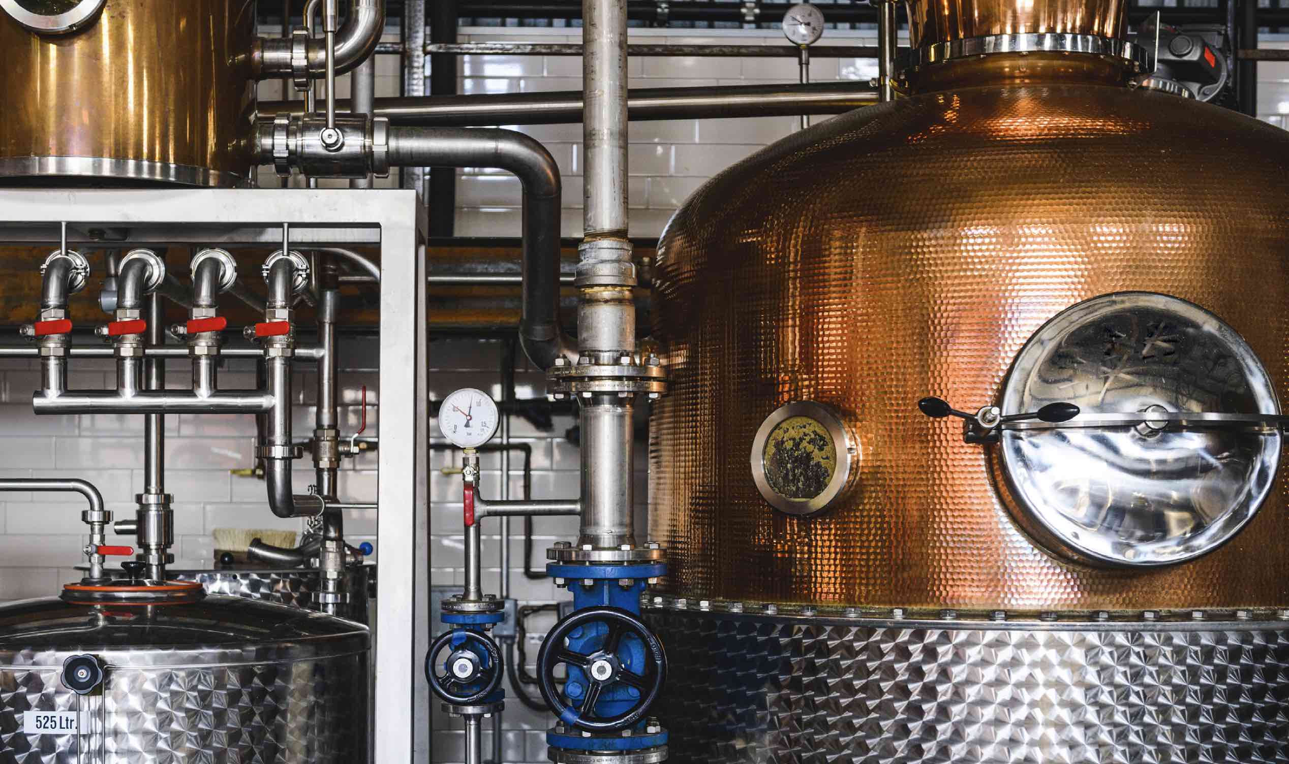 Distilling equipment inside of a distillery.